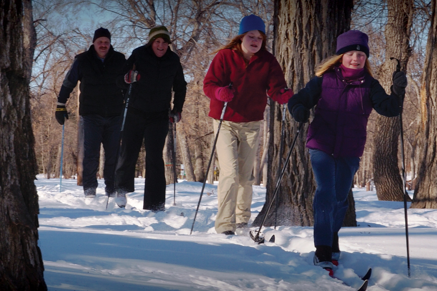 A family of four enjoying the great cross country ski trails.